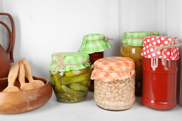 Jars with pickled vegetables on shelf