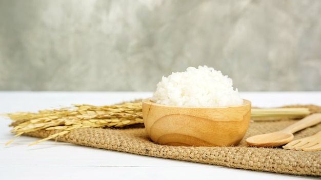 Jasmine rice in a bowl on a wooden table.