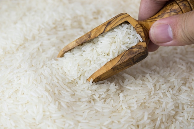 Jasmine rice in a wooden scoop