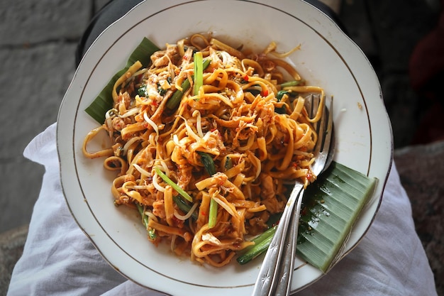 Javanese Fried Noodles or Javanese noodles or Javanese noodles with spoon and fork