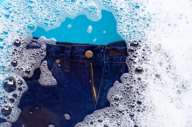 Jeans soak in powder detergent water dissolution.