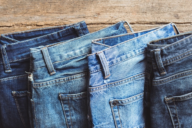 Jeans stacked on a wooden board