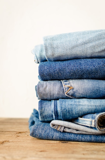 Jeans stacked on a wooden table