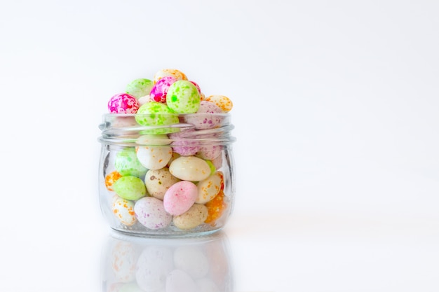 Jelly beans sugar candy snack in a jar on white background