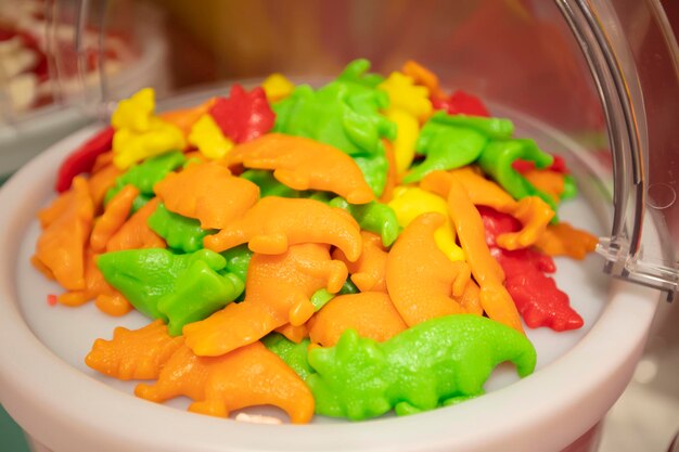 Jelly candies in containers in a store Large selection of sweets in different colors Sale of sweets