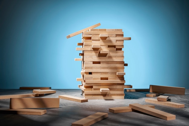 Photo jenga game, a tower of wooden blocks on blue