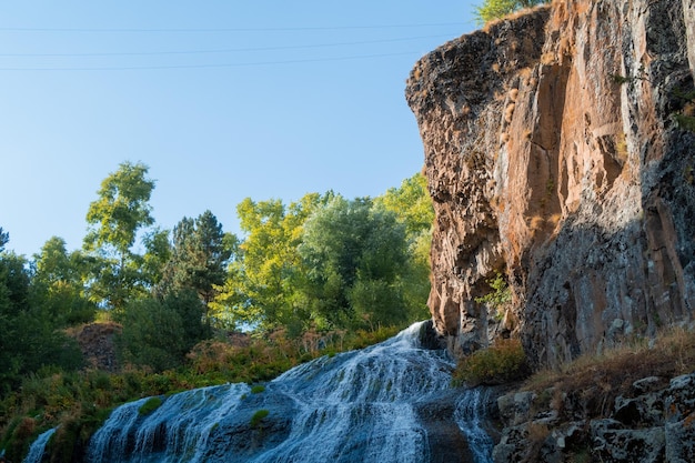 Jermuk waterfall flowing stream picturesque view among the canyon rocks sunlit gorge Armenian stock photography