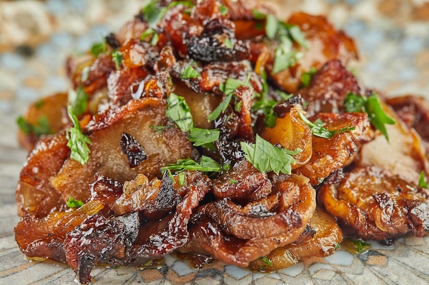 Jerusalem artichoke with shallots and herbs fried in pan. Close up