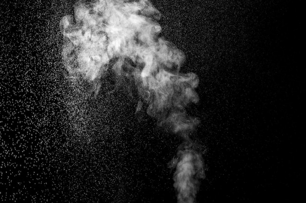 A jet of hot steam with splashes The movement of hot steam with water droplets is highlighted on a black