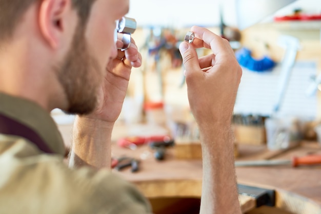 Jeweler Appraising Ring in Shop