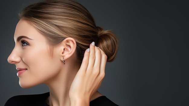 Jewelry concept Portrait of beautiful young female model wearing silver earrings Closeup of woman with clean skin posing in studio background