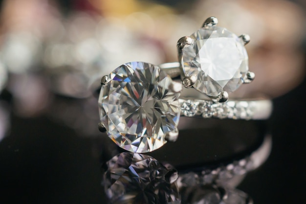 Jewelry diamond rings on black surface with reflection