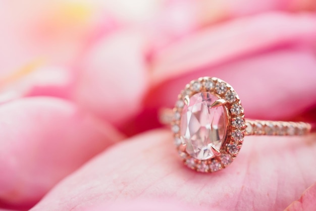 Jewelry pink diamond ring on beautiful rose petal background close up