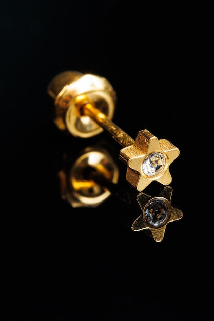 Jewelry with stones earrings luxury golden earrings with diamonds jewels on a black background