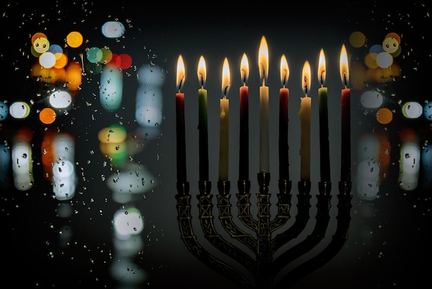 Jewish Religion holiday symbol for Hanukkah in hanukkiah Menorah with burned candles with bokeh