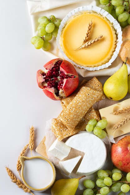 Jewish religious holiday shavuot with dairy products cheesecake pancakes fruits