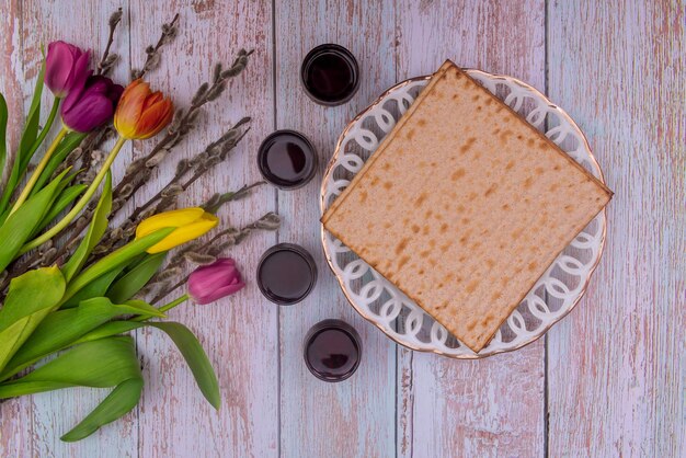 Jewish traditional passover holiday celebration of kosher wine four cup and matzah bread on pesach