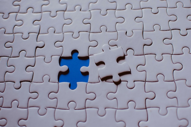 Jigsaw with one piece missing revealing 