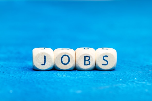 Jobs word made with wooden letter cubes on a gray background