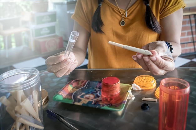 Joint of marijuana in the hands of a woman closeup