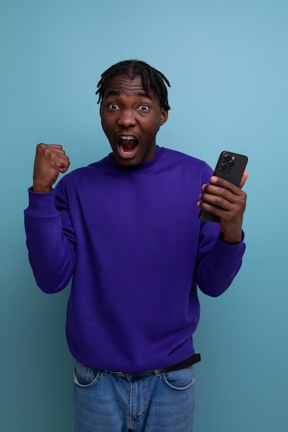 Joyful american young man with dreadlocks won the competition