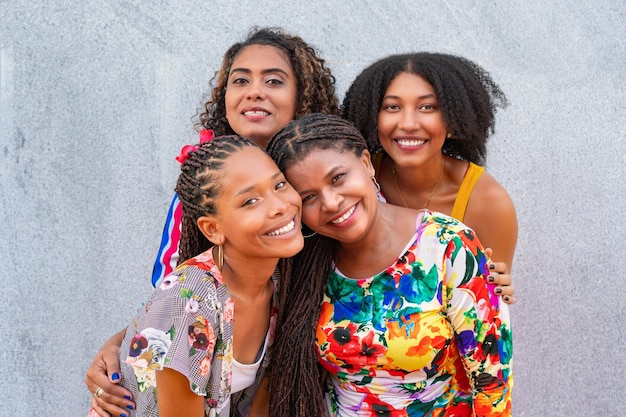 Joyful black women capturing a group selfie in the park radiating happiness