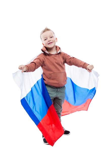 Joyful boy with a big Russian flag Positivity and celebration of Independence Day full height Isolated on white background Vertical