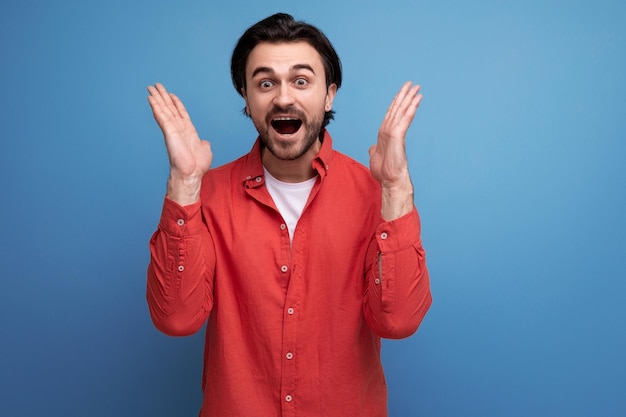 Joyful european brunette year old man in a shirt is happy