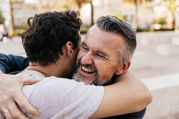 Joyful father and son hugging