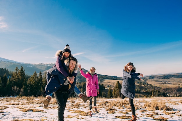 joyful group of young people in the mountains