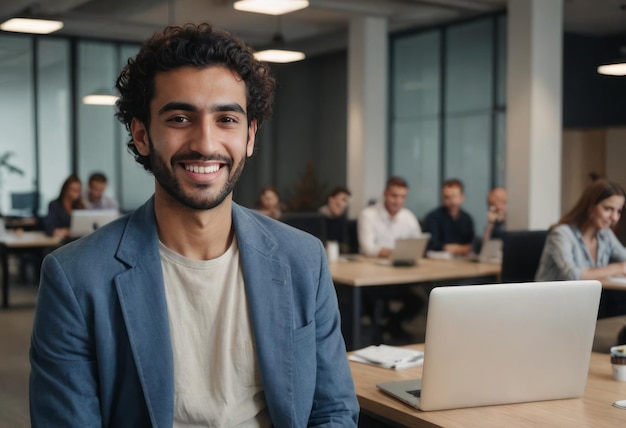 Joyful male professional in a meeting room man with colleagues in background at work