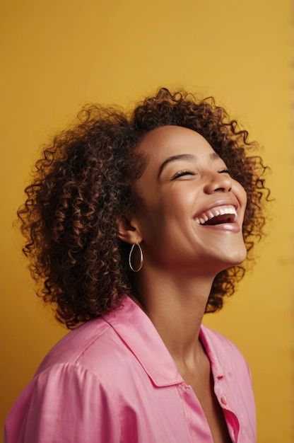 Joyful portrait of a beautiful African American woman laughing against vibrant background