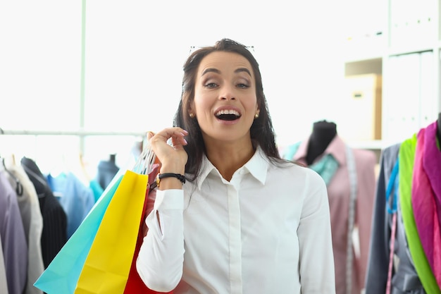 Joyful shopping woman holding shopping bags concept