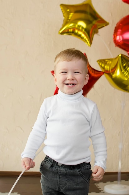 A joyful smiling little boy toddler waisthigh portrait