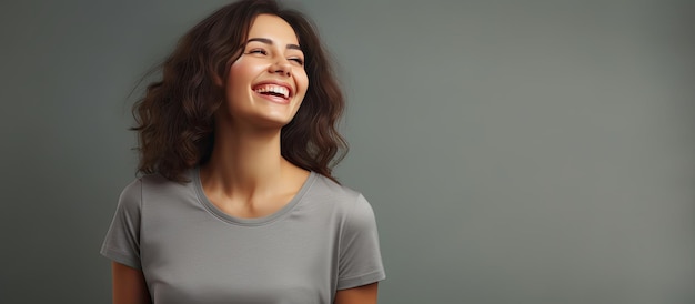 Joyful woman in gray shirt isolated with room for text