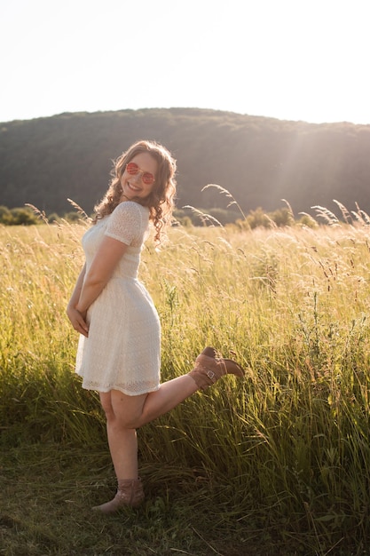 The joyful young woman in sunglasses pleasure nature