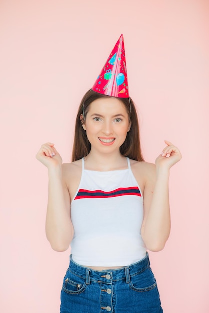 Joyous attractive young long haired woman in cap being excited and surprised