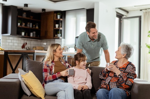 Joyous Family Celebrating Grandmothers Birthday With Cake in a Cozy Living Room