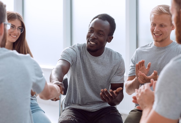 Jubilant group of young people applauds in the conference room