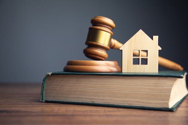 Judge auction and real estate concept. House model, gavel and law books