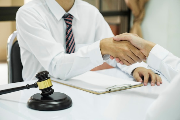 Judge and Businessman shaking hands after behindthescenes advice at attorney services concept courtroom