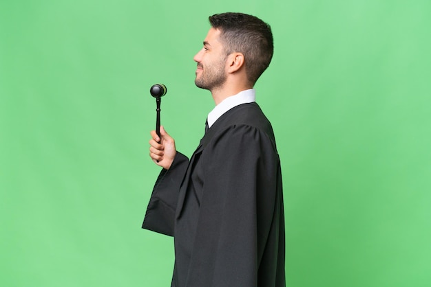 Judge caucasian man over isolated background laughing in lateral position