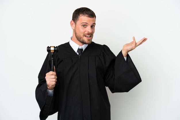 Judge caucasian man isolated on white background extending hands to the side for inviting to come