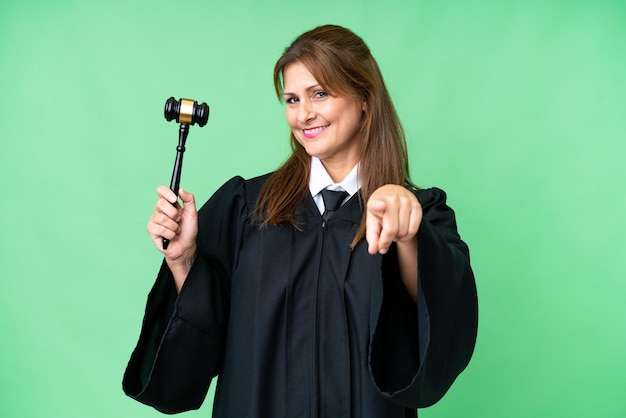 Judge caucasian woman over isolated background pointing front with happy expression