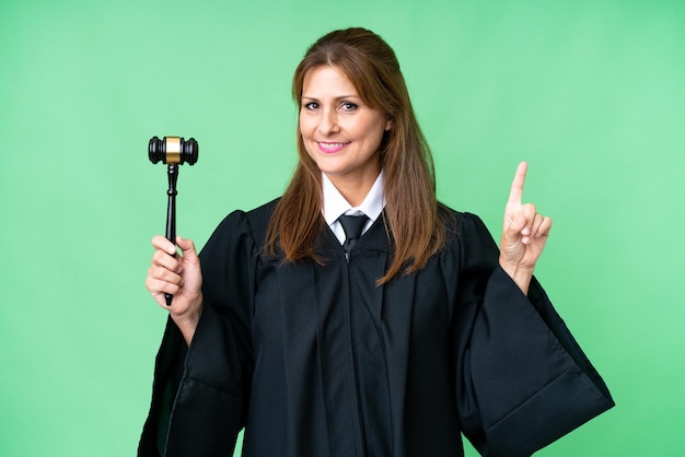 Judge caucasian woman over isolated background showing and lifting a finger in sign of the best