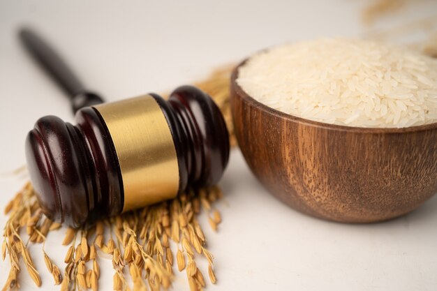 Judge gavel hammer with good grain rice from agriculture farm. Law and justice court concept.