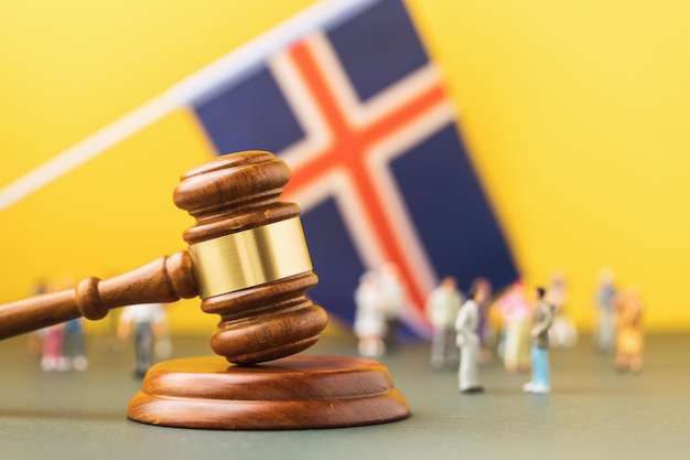 Judge gavel Icelandic flag and plastic toy men the concept of litigation in Icelandic society