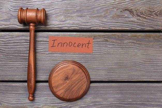 Judge gavel and innocent verdict. Browm wooden hammer.