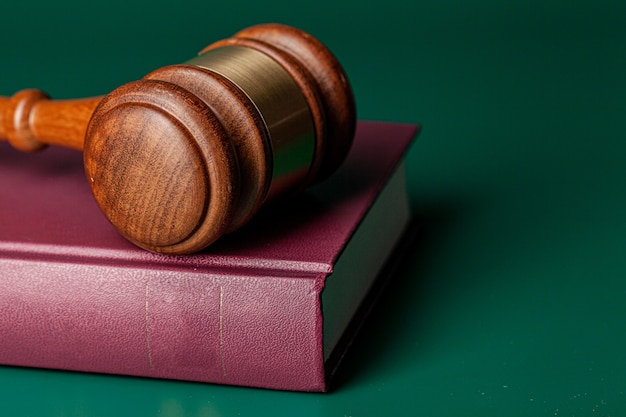 Judge gavel and legal book close up on table