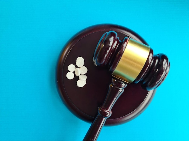 Judge gavel and pills Litigation related to pharmaceuticals and law in medicine